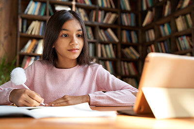 School girl studying using library hotspot lending program