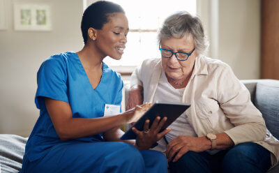 Nurse Using Internet for Healthcare Nonprofits with Senior Woman